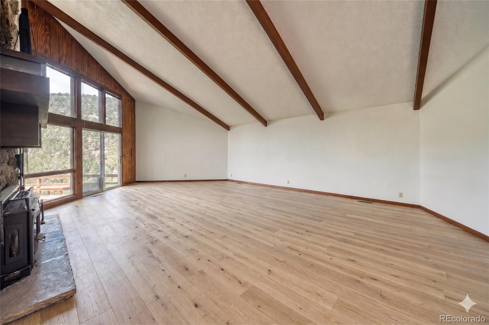 15351 Chimney Rock Road Nathrop, CO 81236 - Photo 25 of 48 a view of empty room with wooden floor and fan
