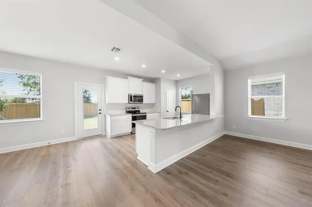 a view of kitchen with wooden floor and windows