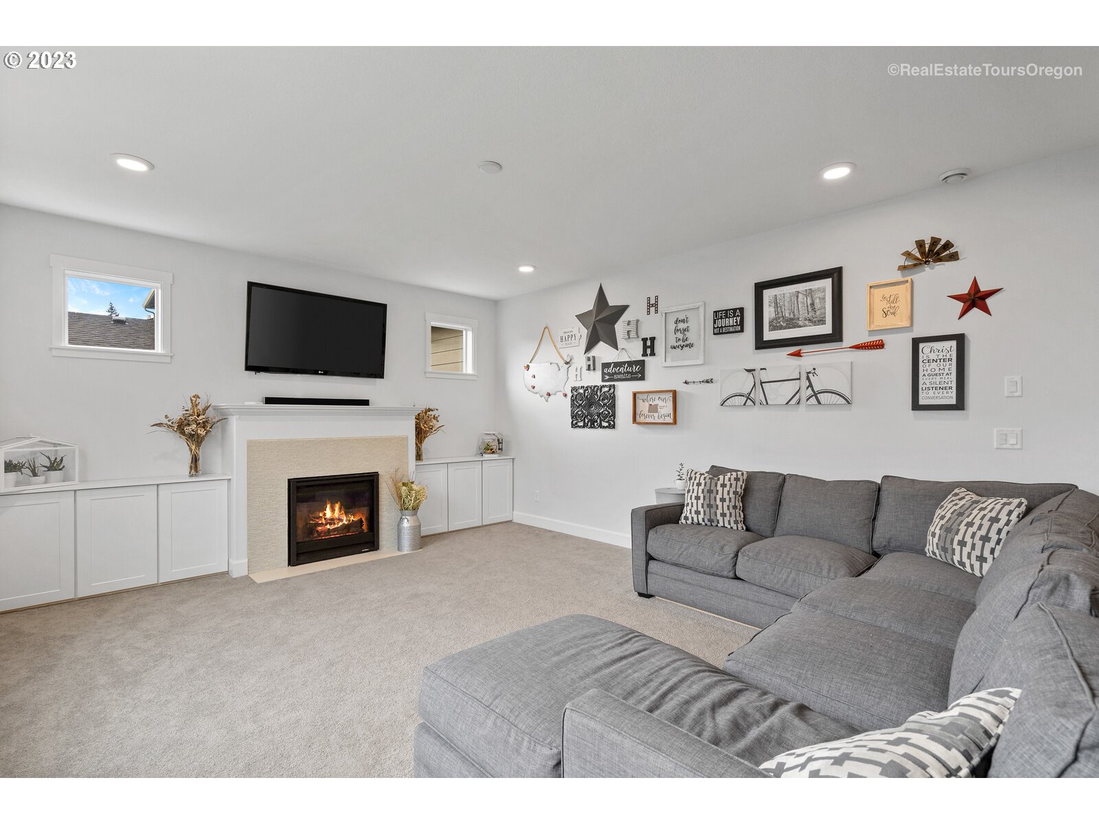 4584 North 9th Street Ridgefield, WA 98642 - Photo 11 of 39 a living room with furniture a flat screen tv and a fireplace