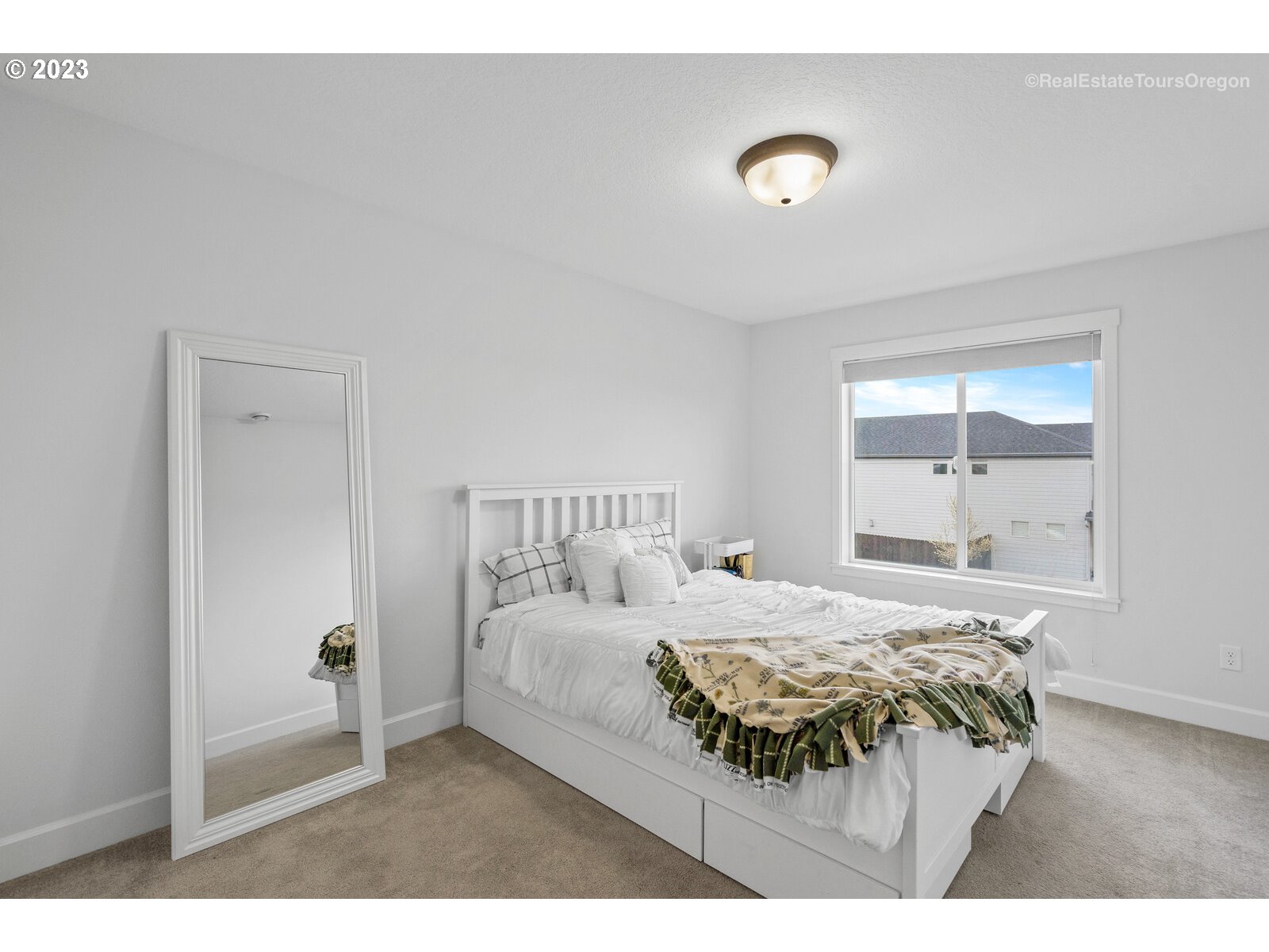 4584 North 9th Street Ridgefield, WA 98642 - Photo 29 of 39 a bedroom with a bed and a large window