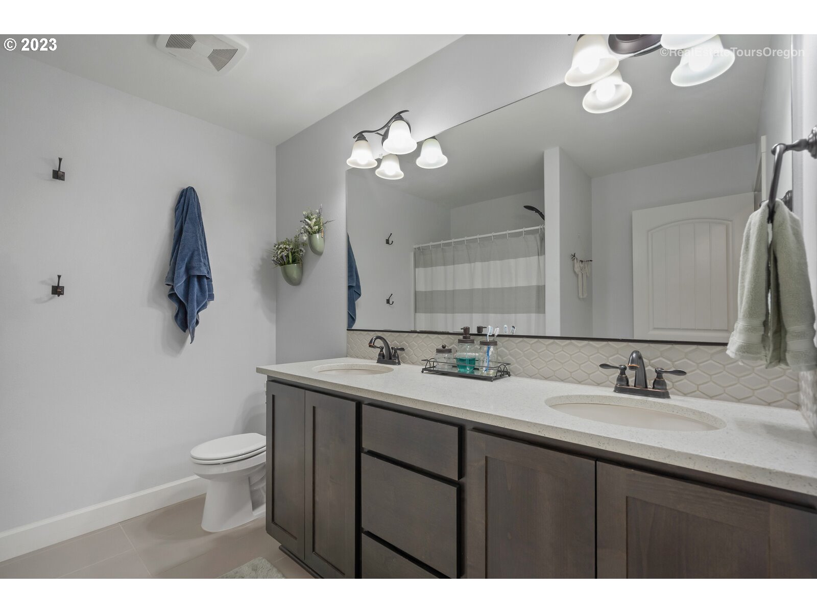 4584 North 9th Street Ridgefield, WA 98642 - Photo 34 of 39 a bathroom with a double vanity sink toilet and a mirror