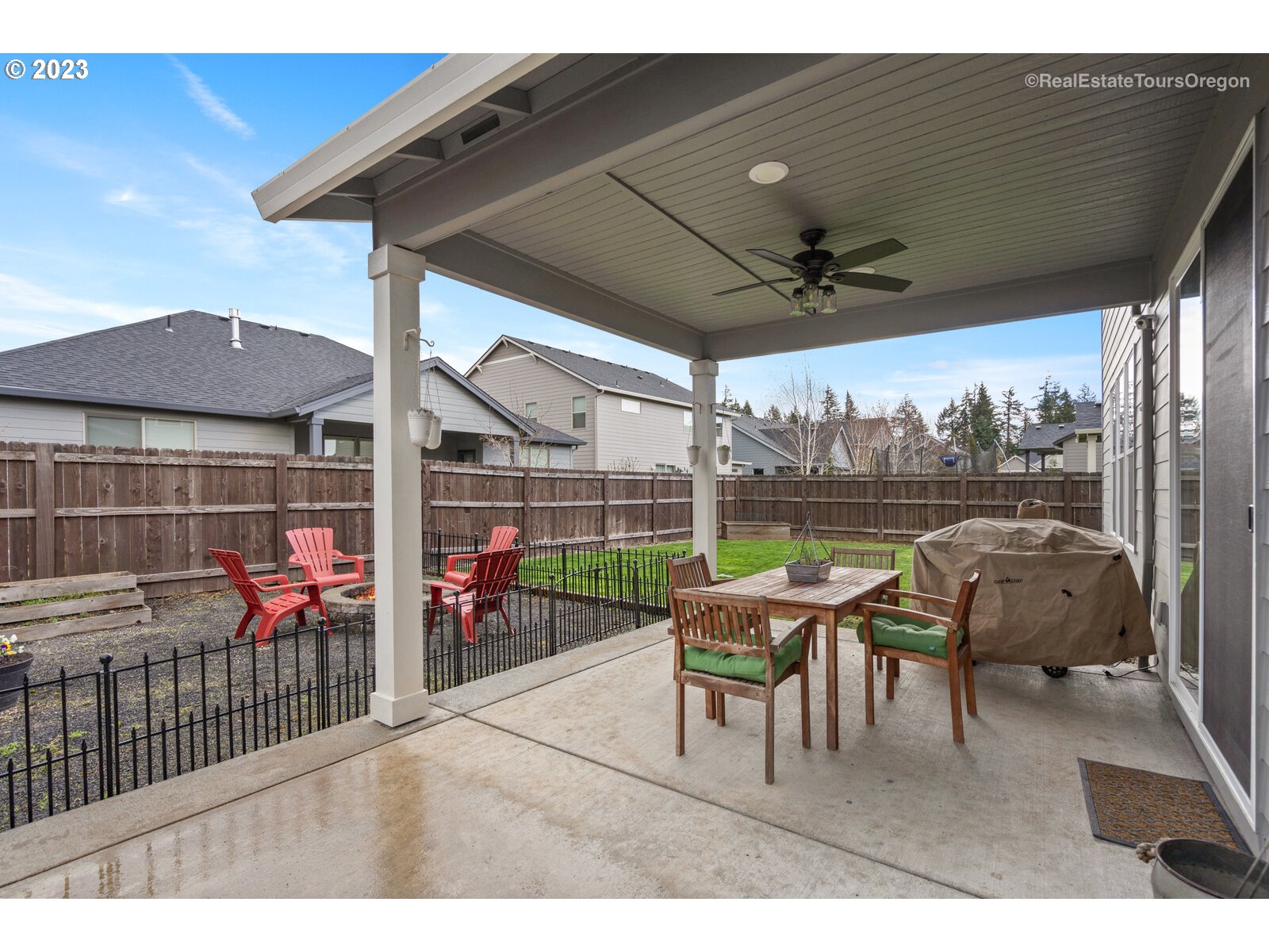 4584 North 9th Street Ridgefield, WA 98642 - Photo 38 of 39 a view of a patio with a table chairs and a floor to ceiling window
