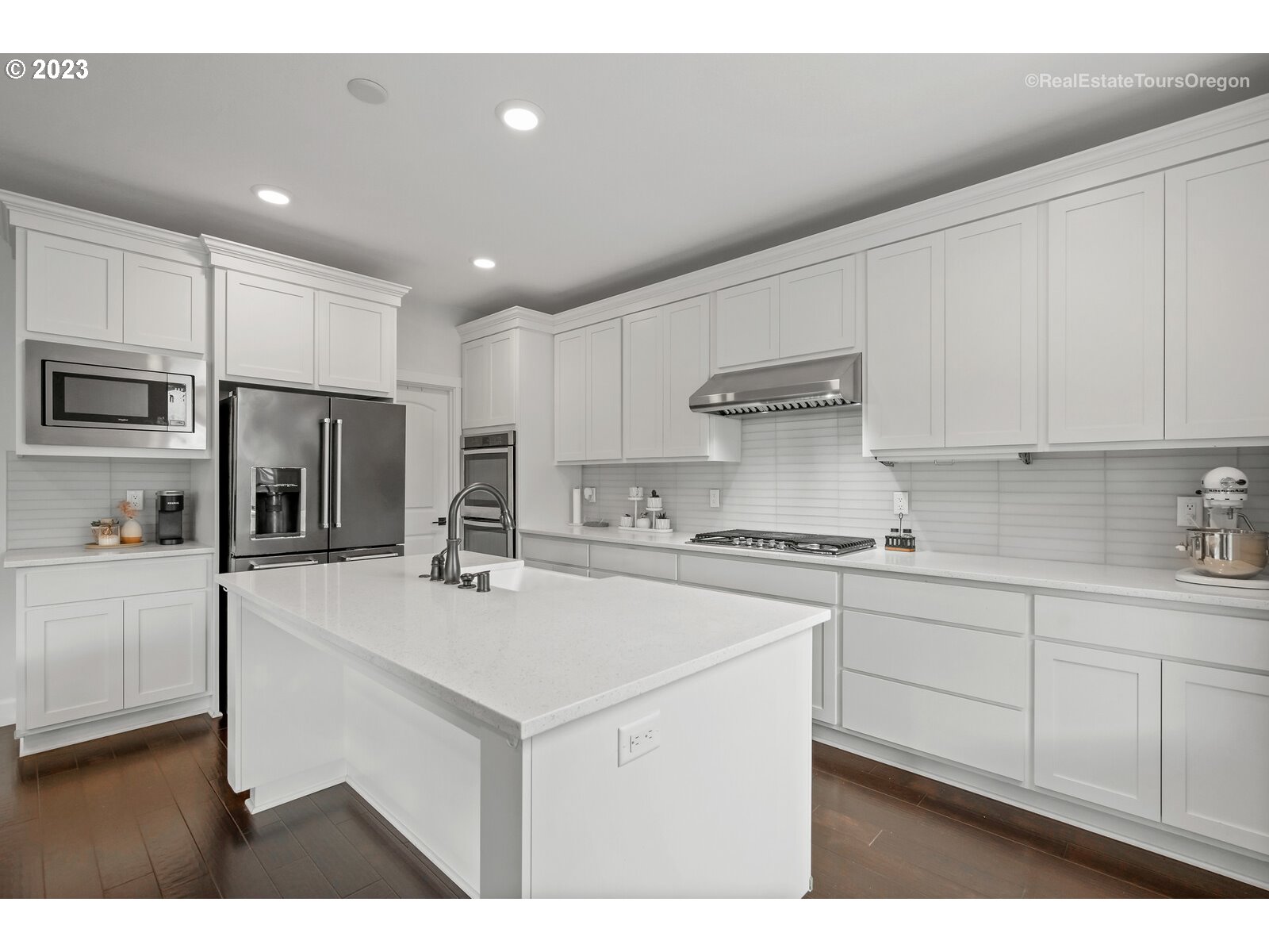 4584 North 9th Street Ridgefield, WA 98642 - Photo 8 of 39 a kitchen with stainless steel appliances sink stove refrigerator and cabinets