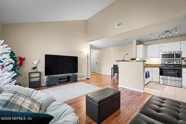 a living room with furniture and a flat screen tv