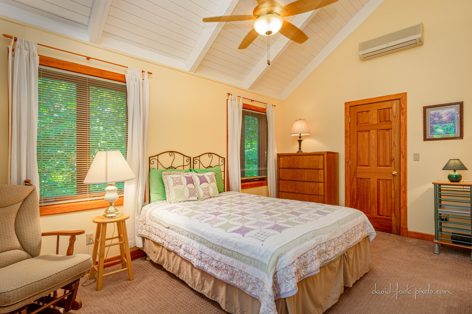 18 Lookout Trace Galena, IL 61036 - Photo 16 of 56 a bedroom with a bed a lamp on dresser and a chandelier