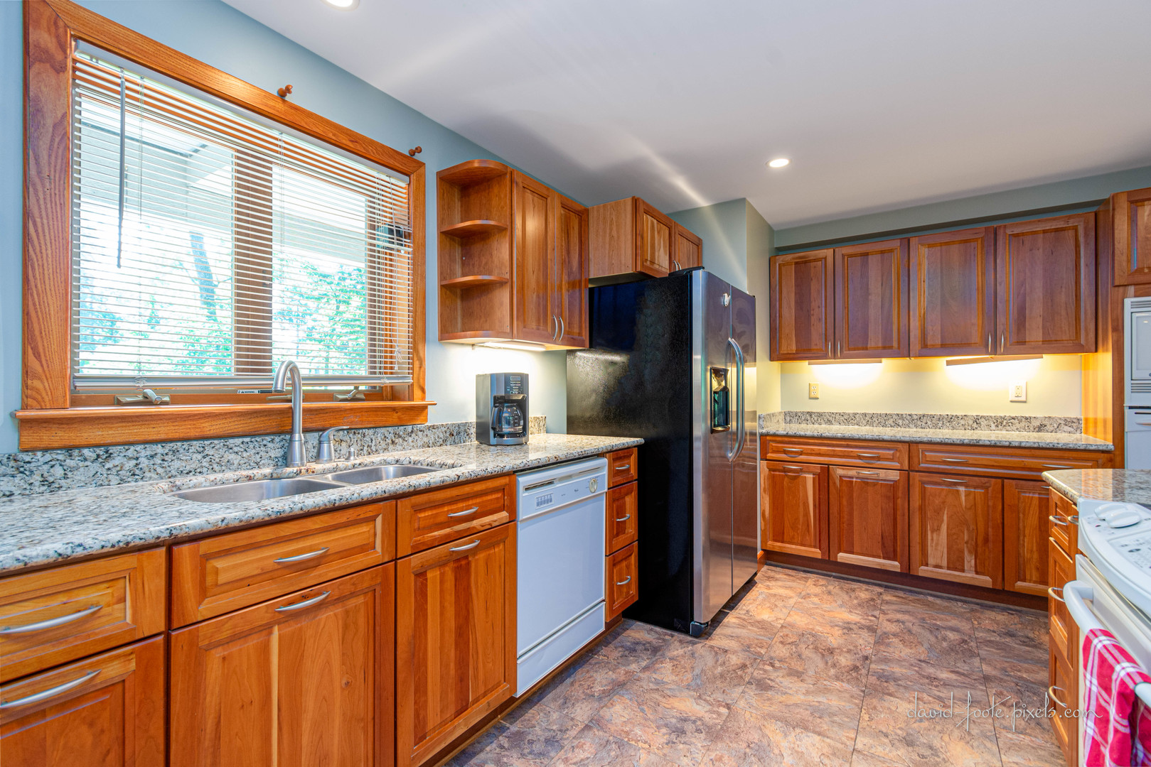 18 Lookout Trace Galena, IL 61036 - Photo 8 of 56 a kitchen with stainless steel appliances granite countertop a refrigerator and wooden cabinets