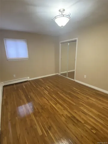 an empty room with a chandelier fan