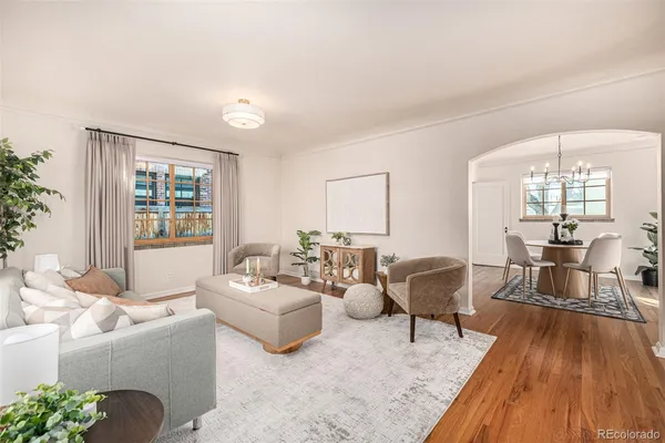 a living room with furniture and wooden floor