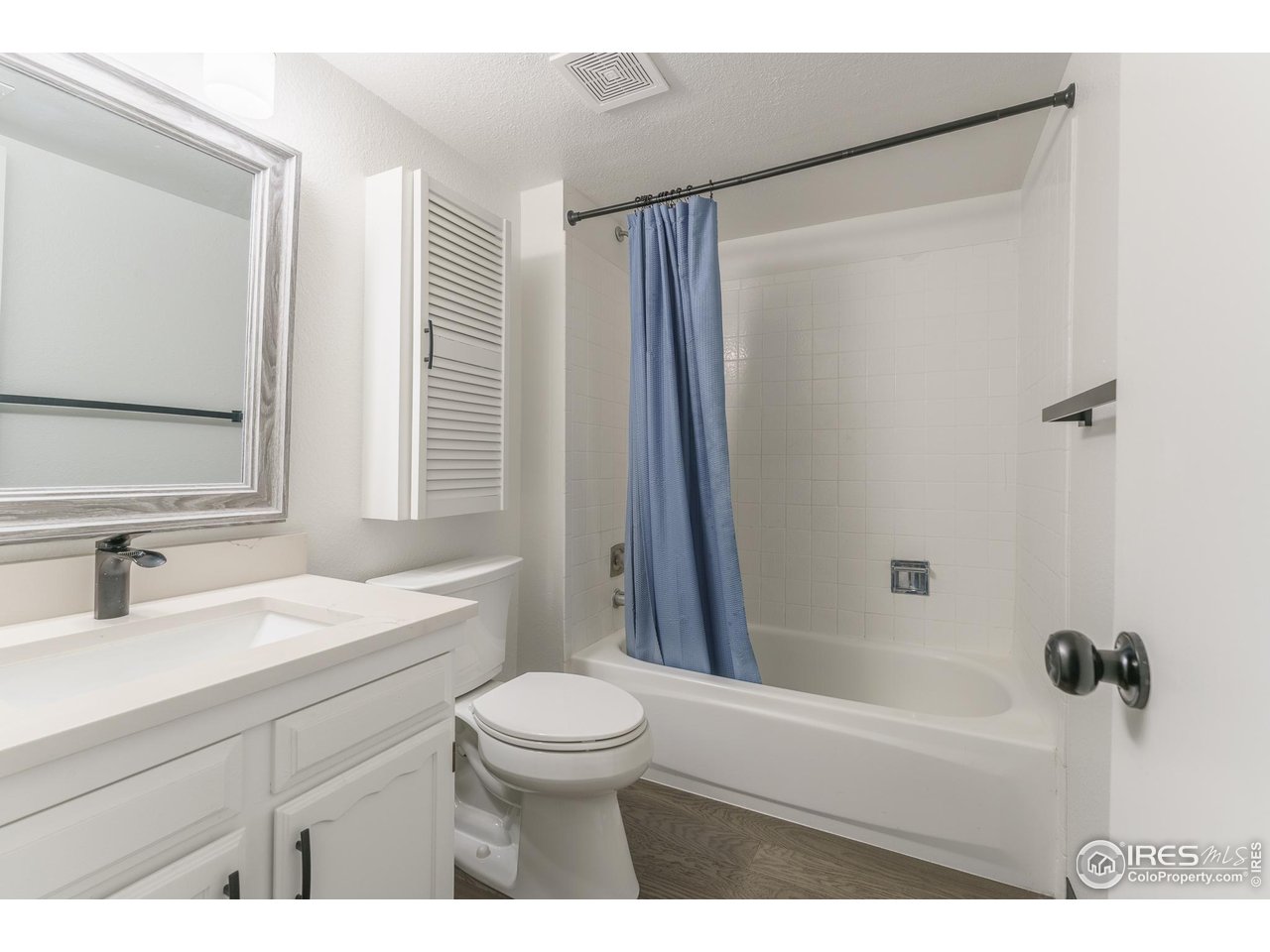 1225 Centaur Circle, Unit A Lafayette, CO 80026 - Photo 19 of 35 a bathroom with a sink a toilet a mirror and shower