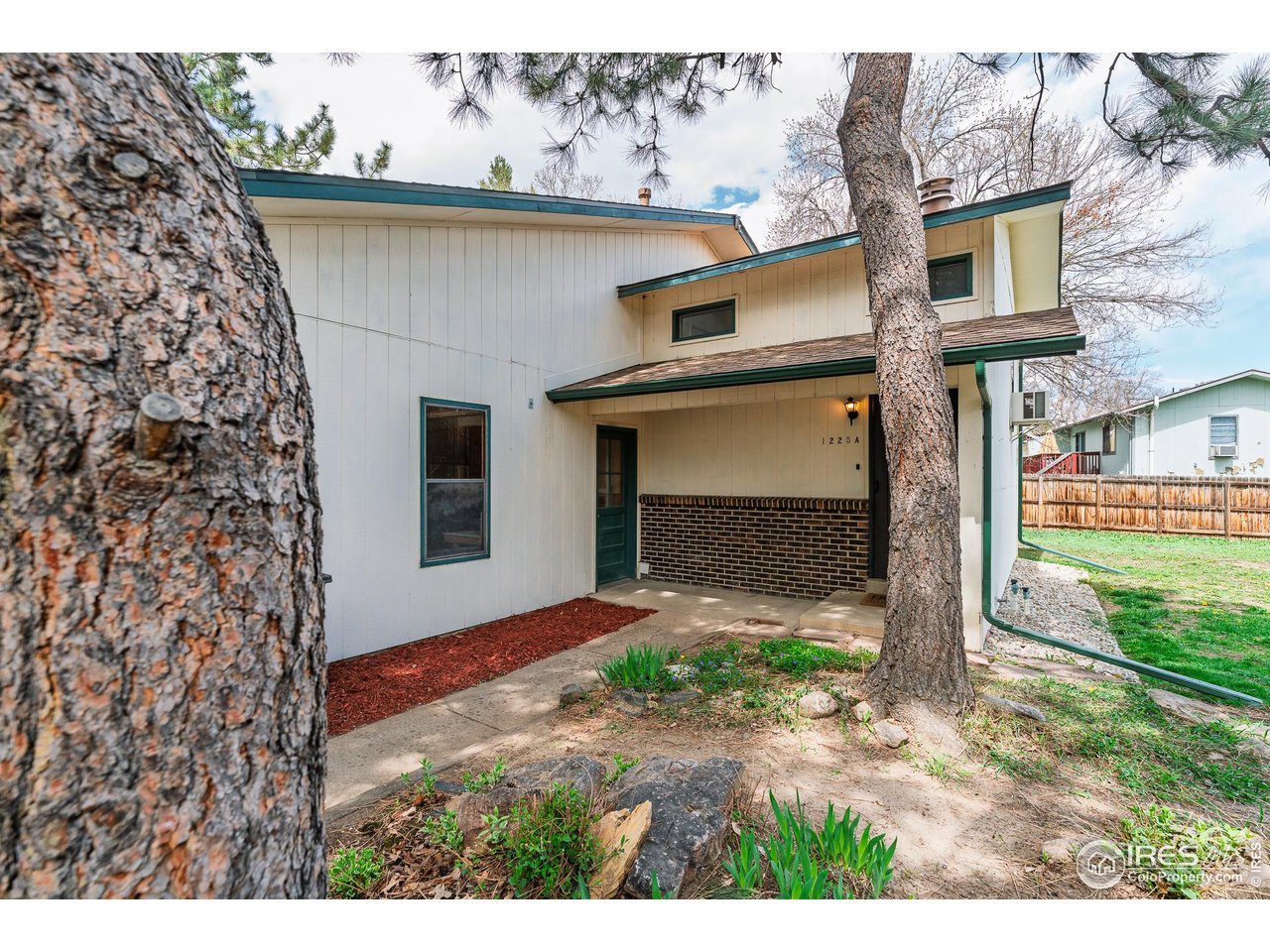 1225 Centaur Circle, Unit A Lafayette, CO 80026 - Photo 26 of 35 a front view of a house with a yard and garage
