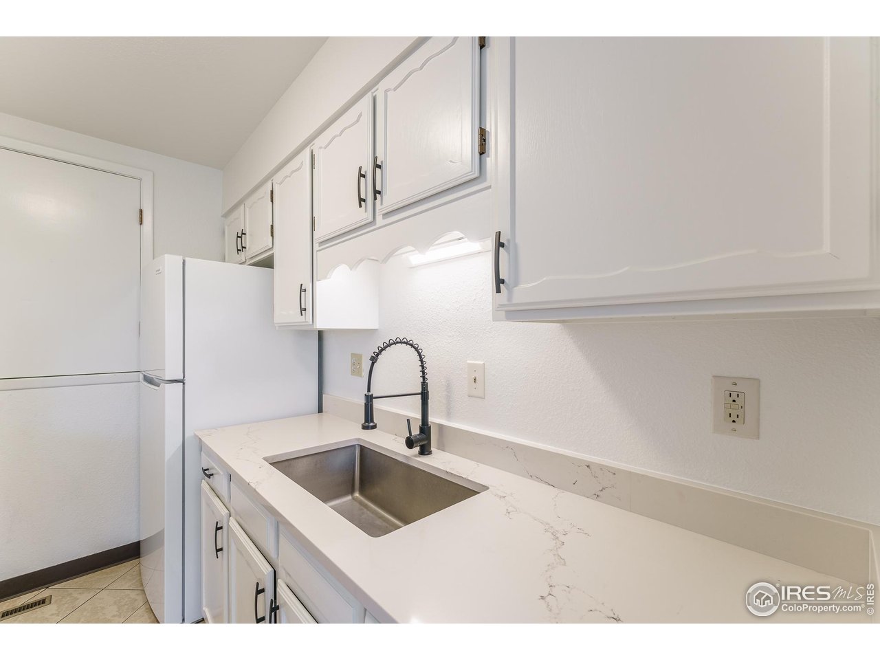 1225 Centaur Circle, Unit A Lafayette, CO 80026 - Photo 3 of 35 a kitchen with stainless steel appliances a sink a refrigerator and cabinets