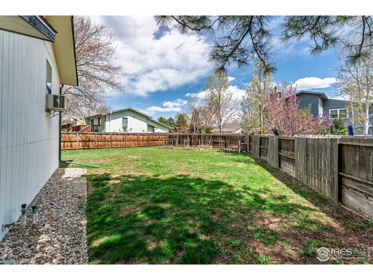 1225 Centaur Circle, Unit A Lafayette, CO 80026 - Photo 33 of 35 a view of a house with a big yard potted plants and large tree