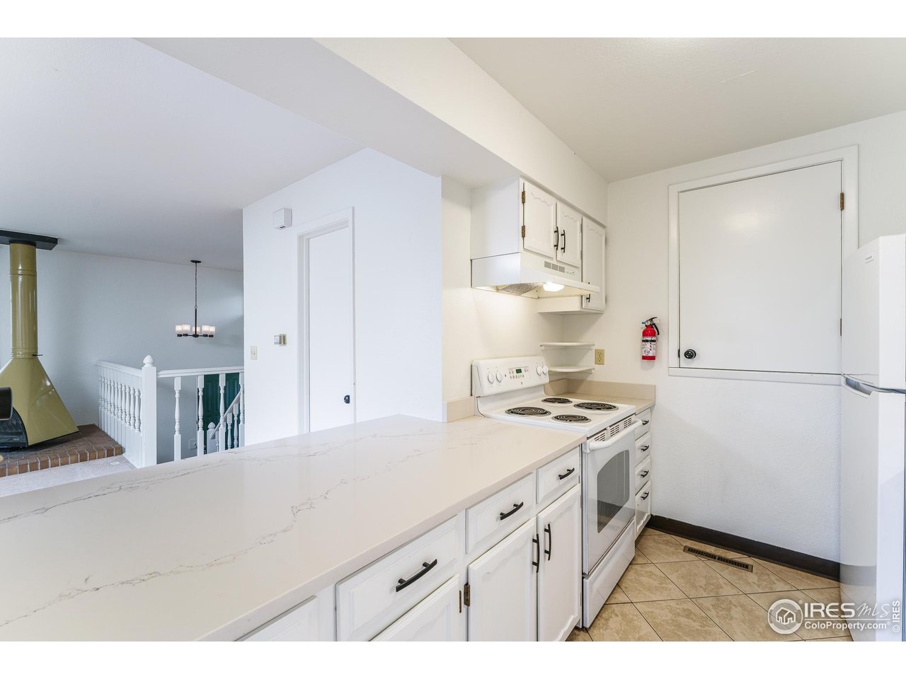 1225 Centaur Circle, Unit A Lafayette, CO 80026 - Photo 4 of 35 a kitchen with a stove a sink and a refrigerator