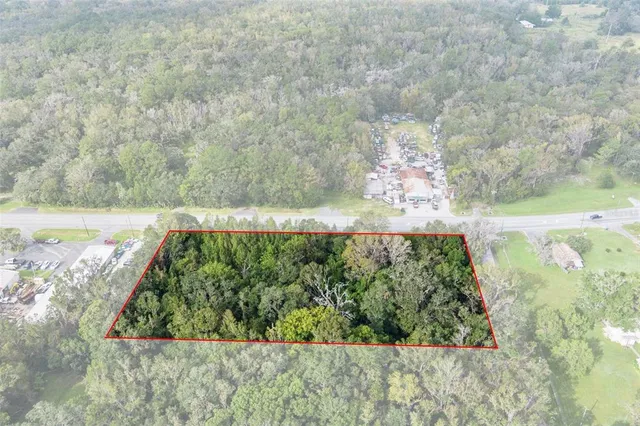 a view of a yard with wooden fence