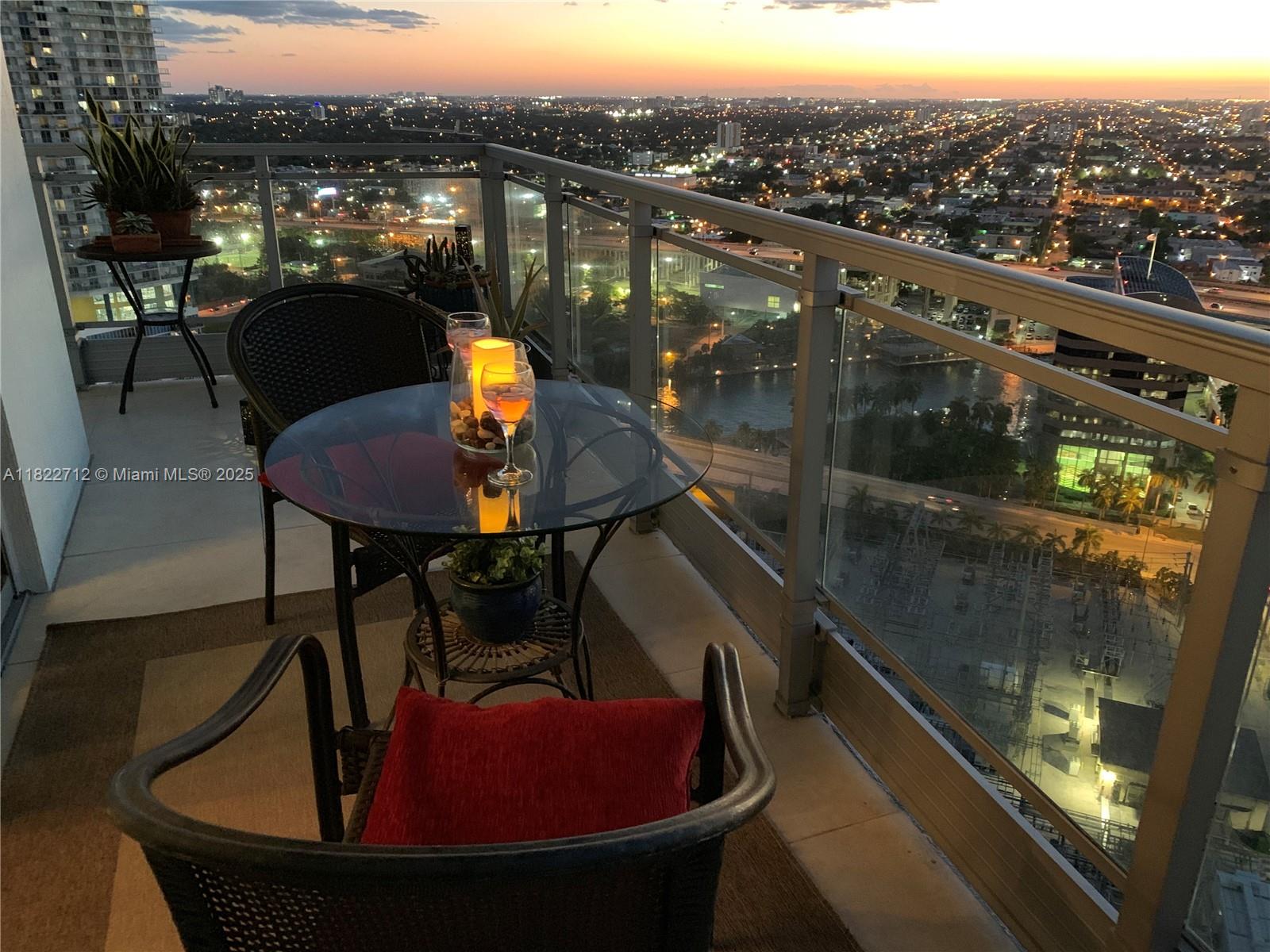 90 Southwest 3rd Street, Unit 3010 Miami, FL 33130 - Photo 2 of 44 a view of a balcony with a table and chairs