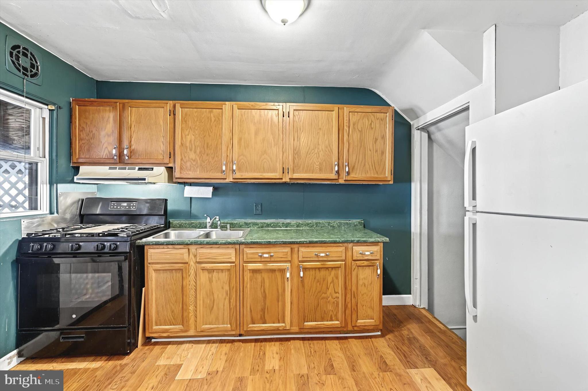 2161 Vailthorn Road Middle River, MD 21220 - Photo 8 of 18 a kitchen with stainless steel appliances granite countertop a stove a refrigerator and a sink