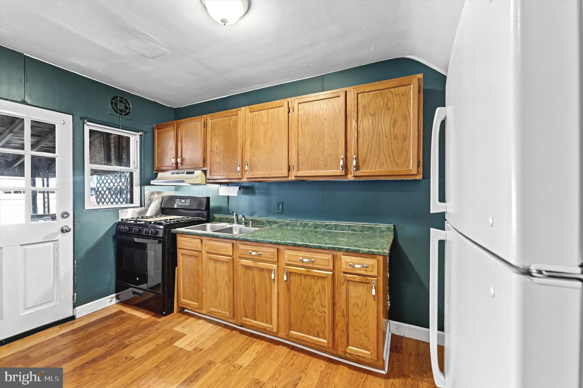 2161 Vailthorn Road Middle River, MD 21220 - Photo 9 of 18 a kitchen with stainless steel appliances granite countertop a stove a sink dishwasher and a refrigerator