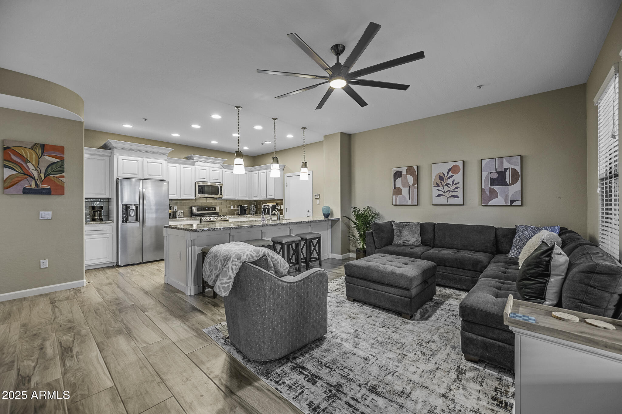a living room with furniture and kitchen view