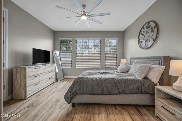 a bedroom with a large bed and a flat screen tv