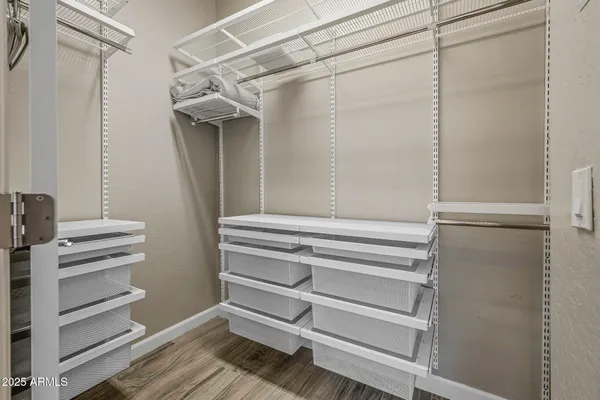 a view of walk in closet with empty racks