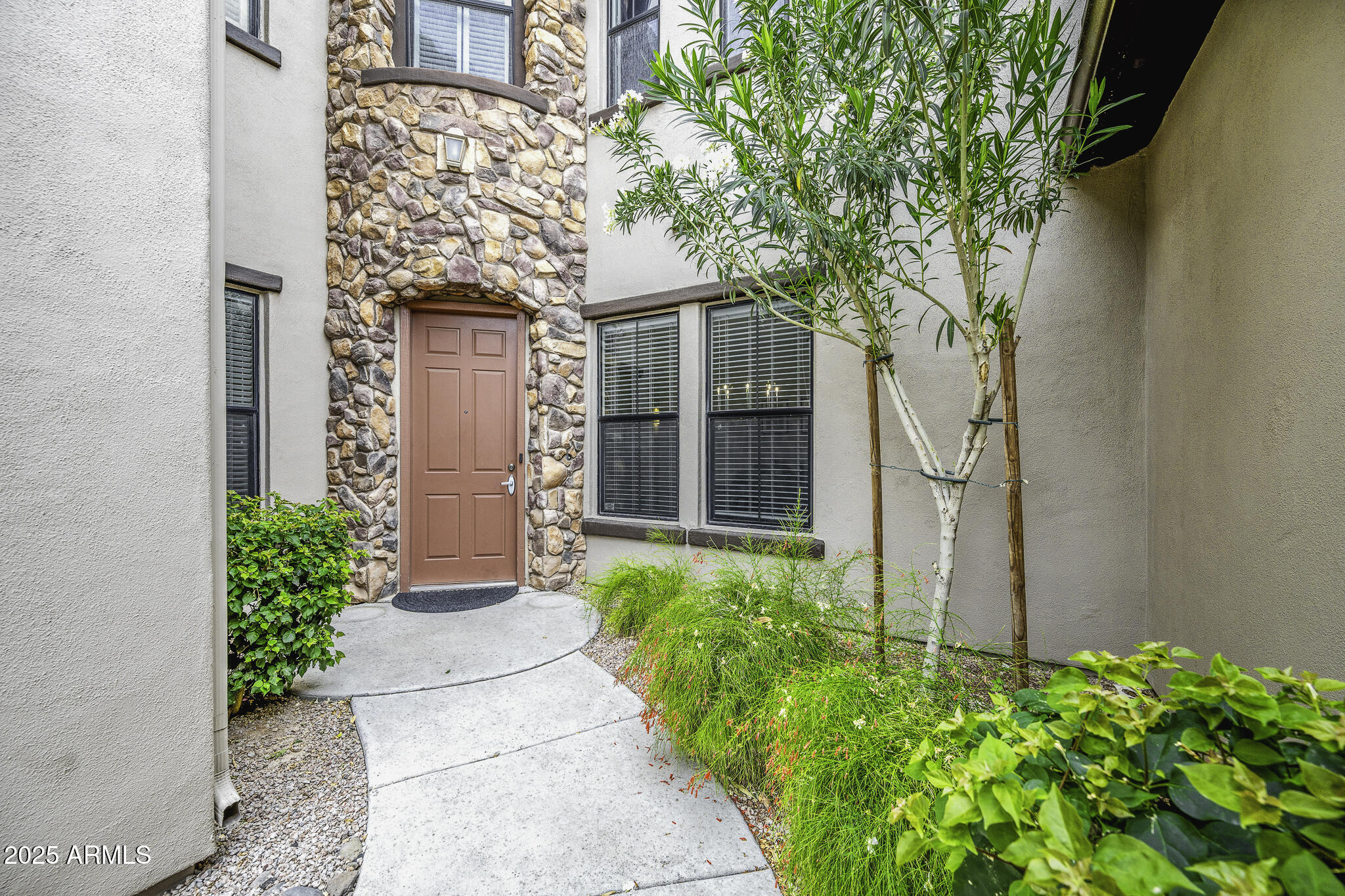 4777 South Fulton Ranch Boulevard, Unit 1044 Chandler, AZ 85248 - Photo 3 of 22 a front view of a house with a yard