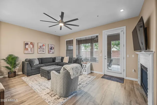 a living room with furniture a fireplace and a flat screen tv