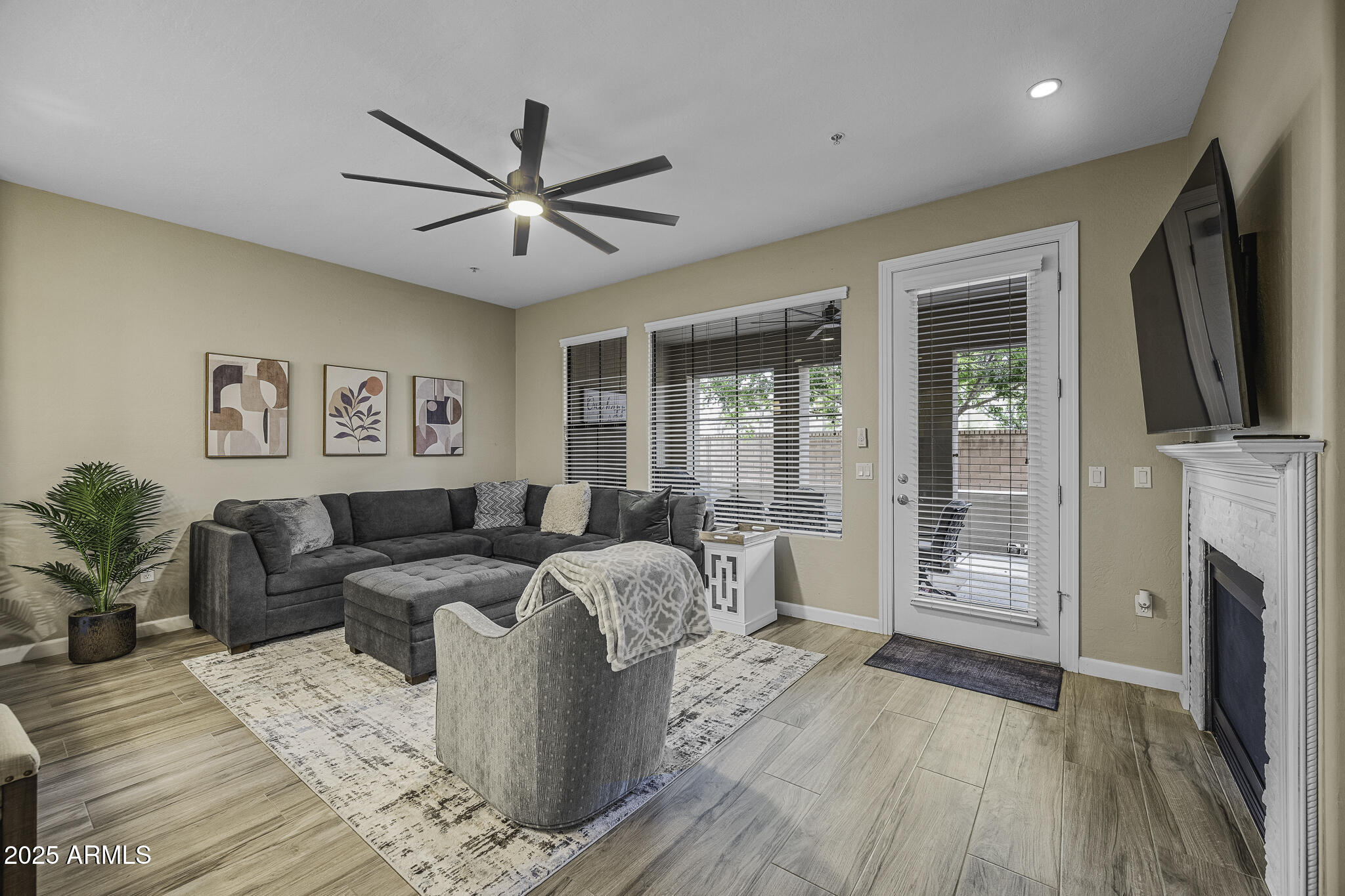 4777 South Fulton Ranch Boulevard, Unit 1044 Chandler, AZ 85248 - Photo 6 of 22 a living room with furniture a fireplace and a flat screen tv