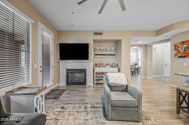 a living room with furniture a fireplace and a flat screen tv