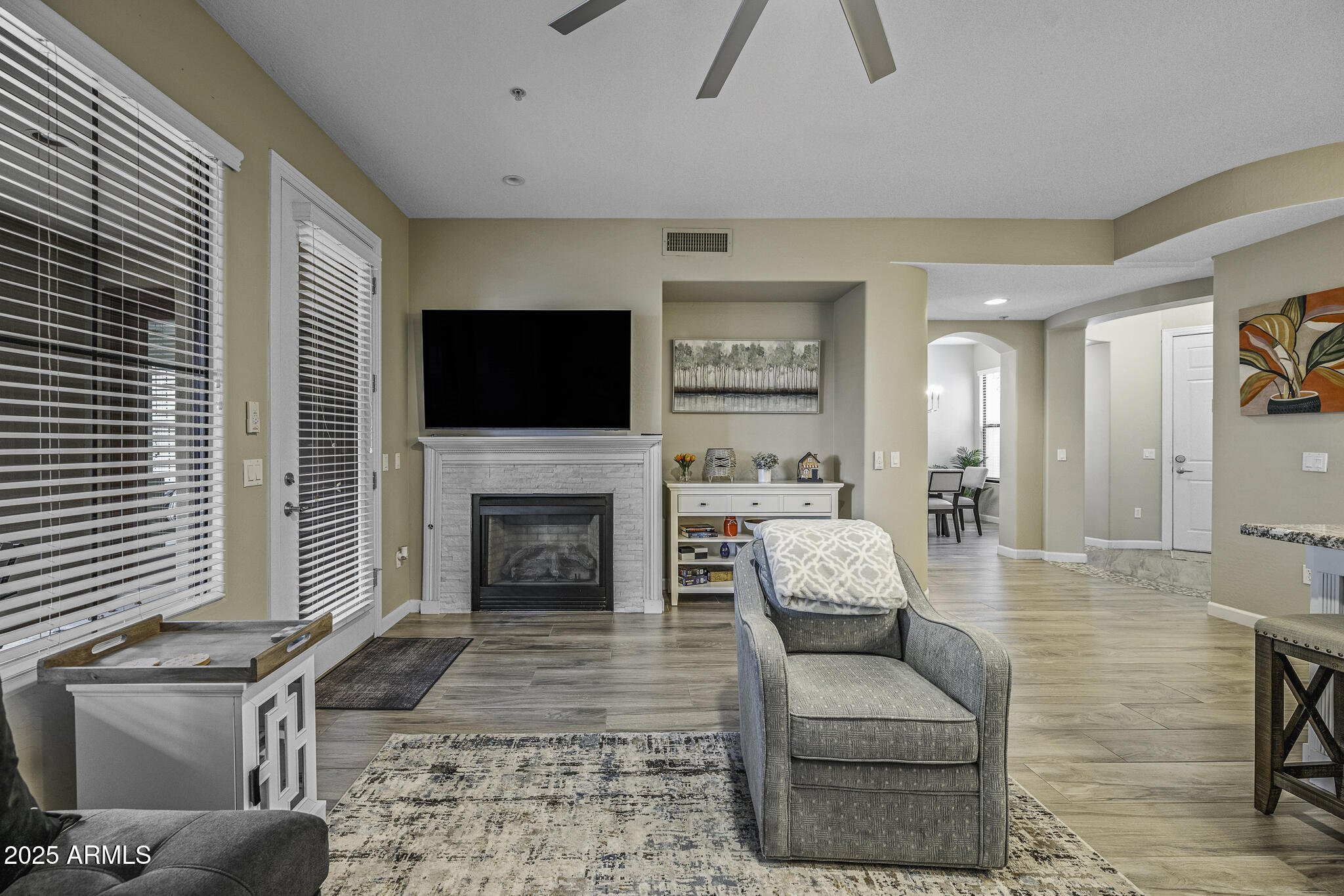 4777 South Fulton Ranch Boulevard, Unit 1044 Chandler, AZ 85248 - Photo 10 of 22 a living room with furniture a fireplace and a flat screen tv