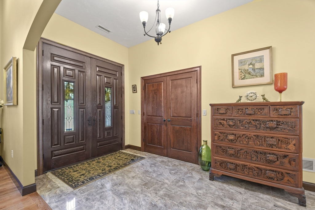 81 Northside Road Charlton, MA 01507 - Photo 5 of 40 a bedroom with a dresser and a chandelier