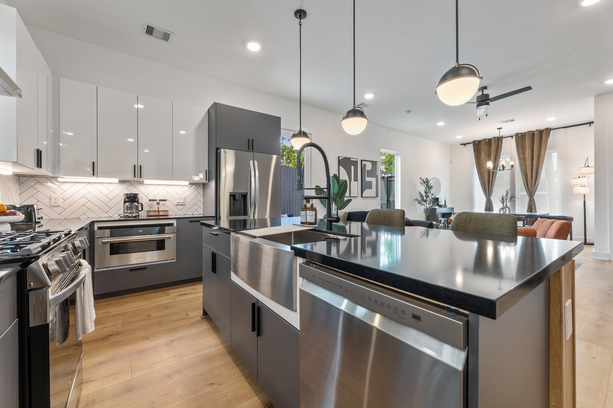 a kitchen with stainless steel appliances granite countertop a sink a stove and a refrigerator