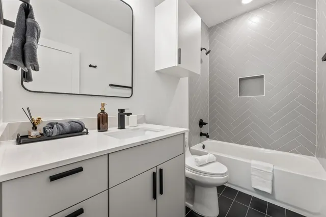 a bathroom with a sink a toilet and mirror