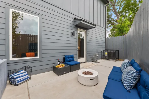 a view of a patio with couches chairs and potted plants