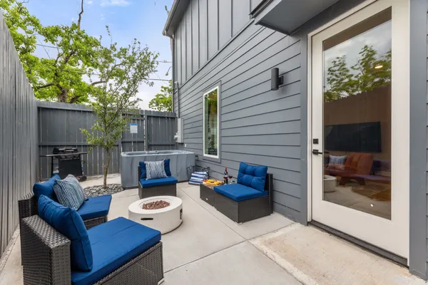 a view of a deck with couches table and chairs and potted plants