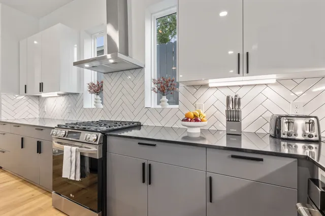 a kitchen with stainless steel appliances granite countertop a stove and a sink