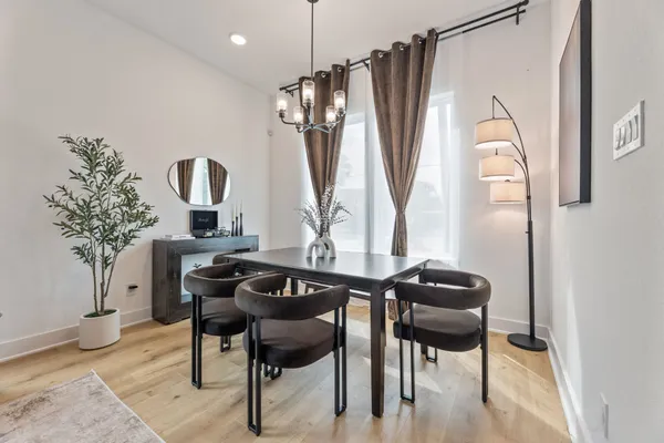 a dining room with furniture and a window