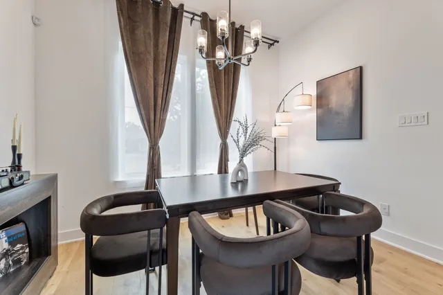 a dining room with furniture and a potted plant