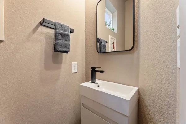 a bathroom with a sink and mirror