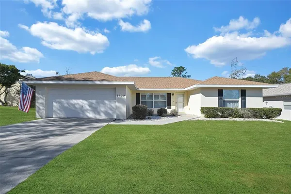 a front view of a house with a garden and porch