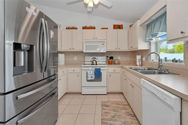 a kitchen with cabinets and appliances