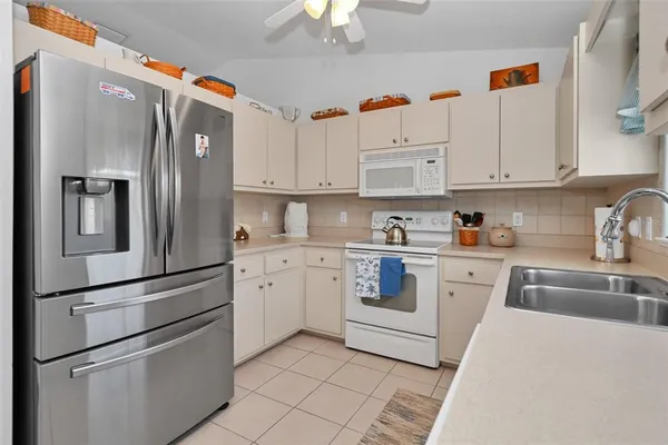 a kitchen with cabinets stainless steel appliances and a sink