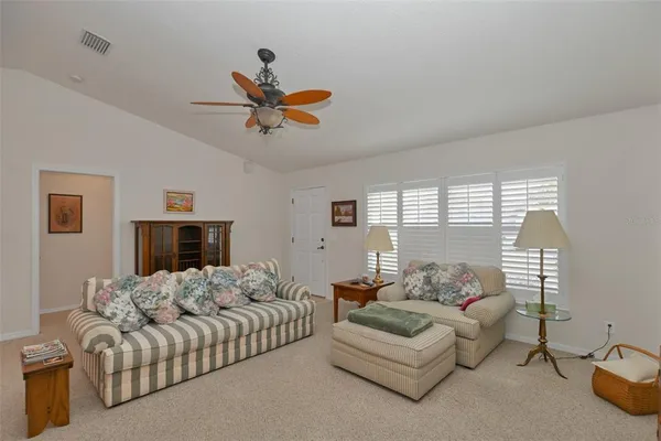 a bedroom with furniture and a large window