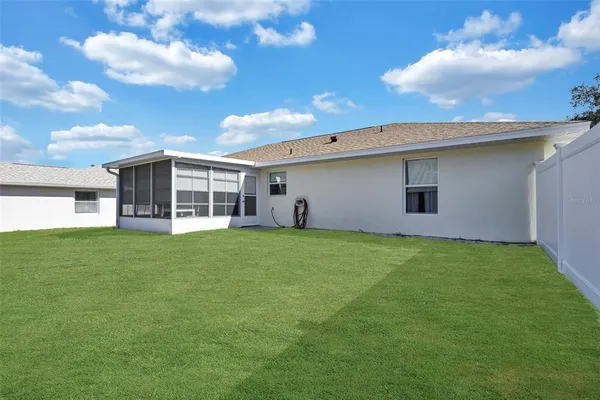 a view of a house with a backyard
