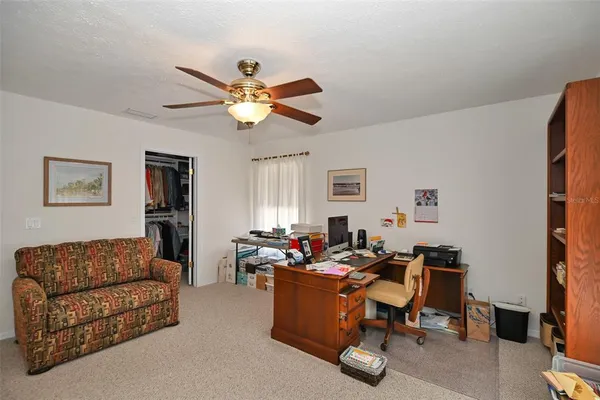 a view of a livingroom with workspace and a couch