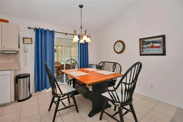 a view of a dining room with furniture and chandelier