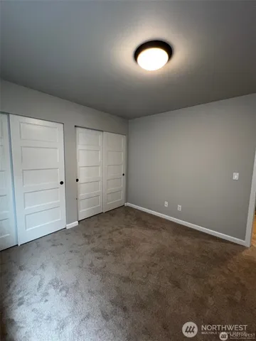 a view of an empty room and closet area