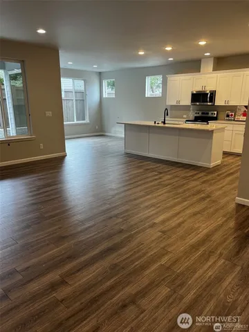 a view of a kitchen with stove and cabinets