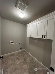a bathroom with a double vanity sink mirror and toilet