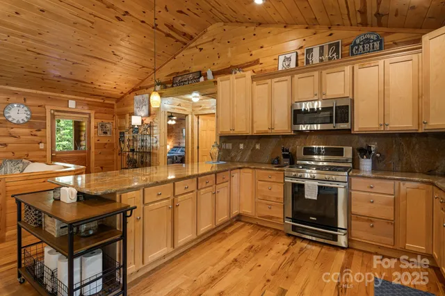 a kitchen with stainless steel appliances a stove sink and cabinets