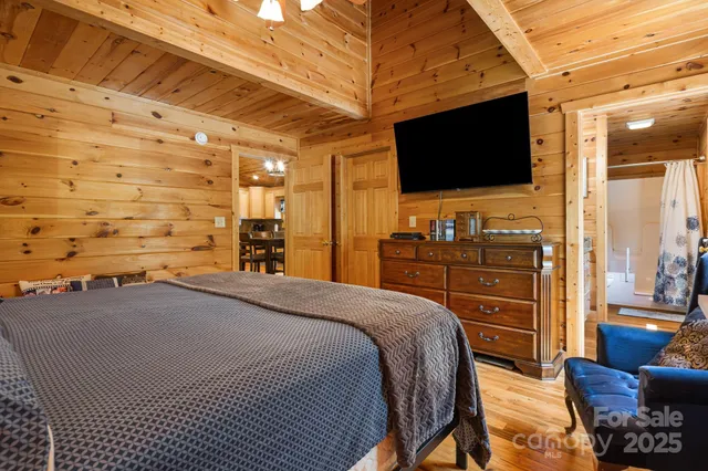 a view of a bedroom with furniture and flat screen tv